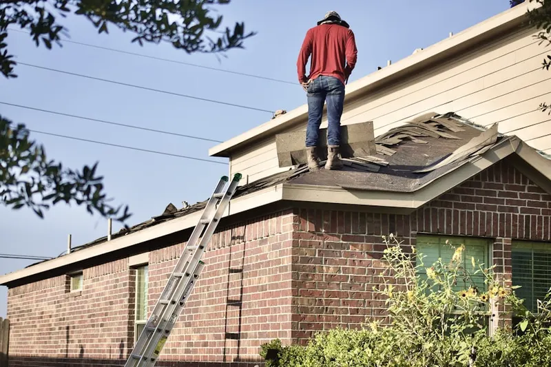Professional roofer working on a residential roof in Downtown Greensboro